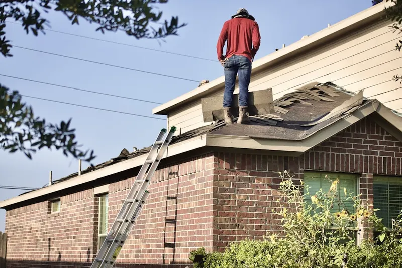 Professional roofer working on a residential roof in Woodmore